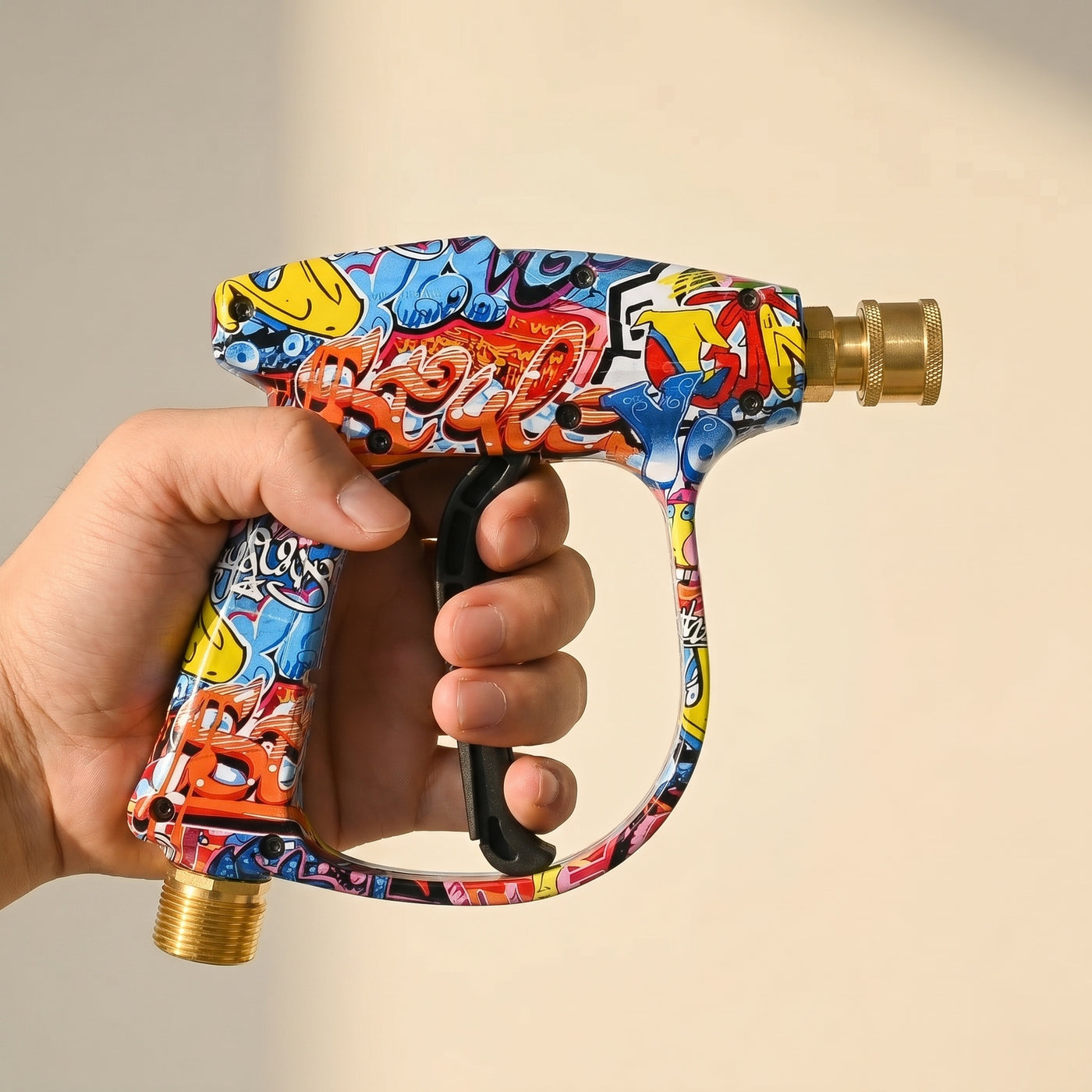 DRIVORA stubby graffiti gun in hand — compact ergonomic scale