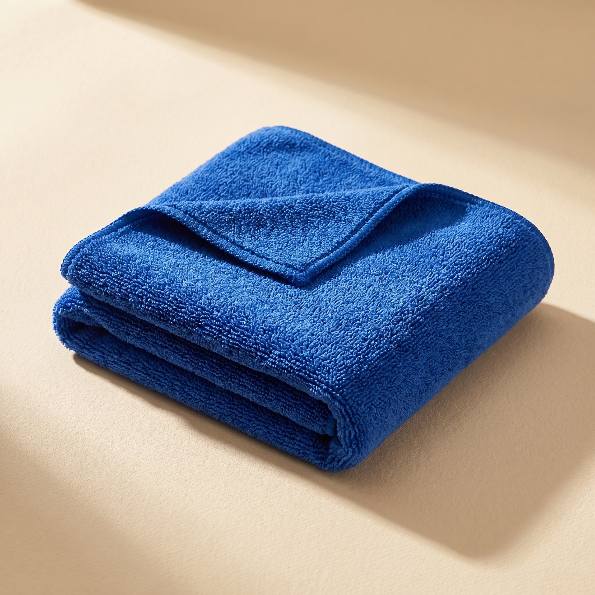 DRIVORA XL Microfiber Drying Towel — single royal blue folded towel on cream beige