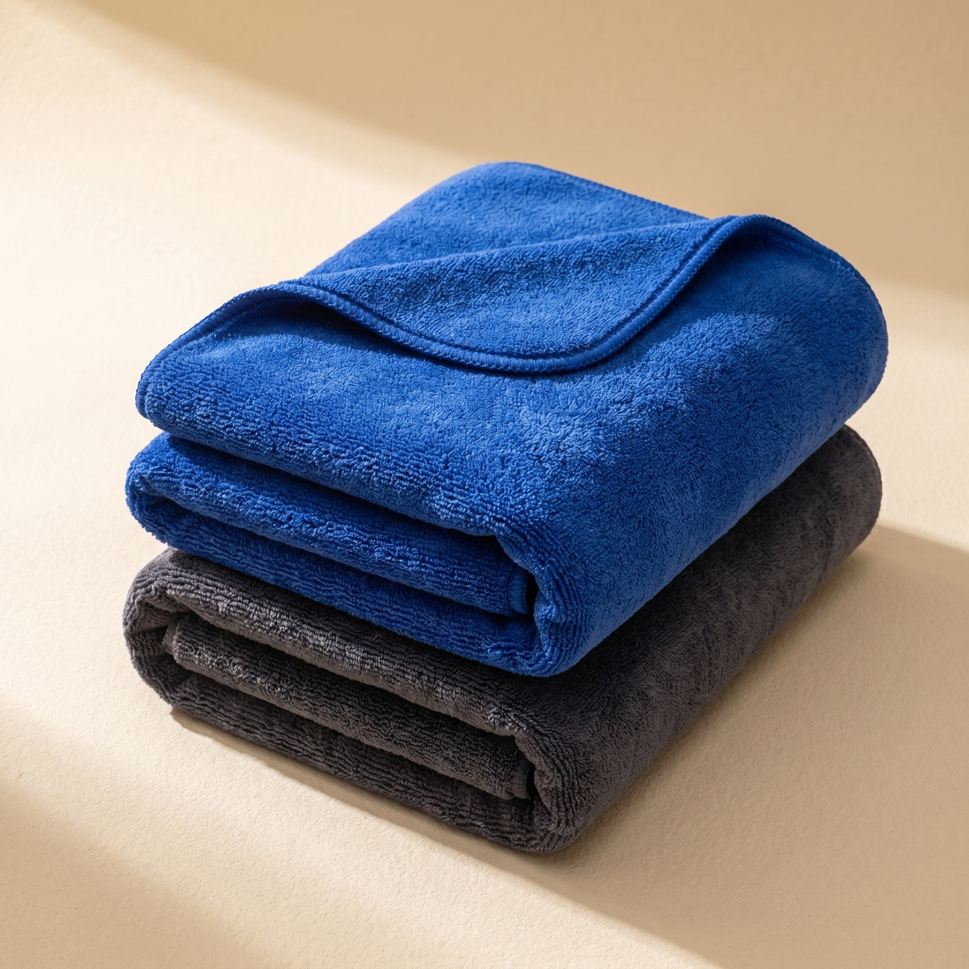 DRIVORA XL Microfiber Drying Towel — blue and charcoal stack hero on cream beige